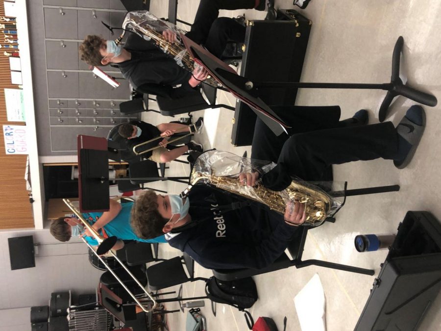 Masking+music%E2%80%A6Practicing+a+piece+for+jazz+band%2C+junior+Nick+Mancini+%28left%29+and+Nevin+Allen+play+their+saxophones+with+specialized+personal+protective+equipment+to+reduce+the+spread+of+COVID-19.+The+instruments+are+covered+with+transparents+jackets+and+each+student+wears+a+mask+with+a+hole+at+the+mouth.+%0AArrowhead+photo+by+Sophie+Rodrique%0A