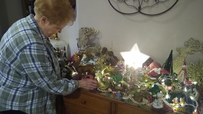 Preparing for Christmas...Decorating the house, Delaware resident Carol Urban works on finishing touches at the table. Each year, Urban and her husband, Richard place many decorations around the inside and outside of their home. 