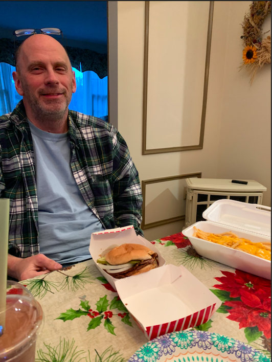 Making the best out of a shutdown...Preparing to indulge in a takeout meal from Freddys Steakburgers in Lansdale is Harleysville resident Andrew Johnson. Since no customers were allowed inside during the shutdown, Pennsylvania residents supported local restaurants through takeout and curbside pickup.  Arrowhead photo by Kathryn Johnson.
