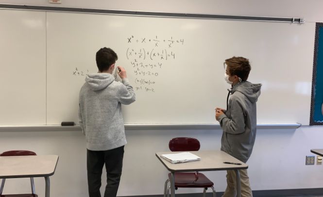 **Hard at work…** *Solving and explaining their first problem of the day, Ariel Levin and Kyle Lockheed work together. The math club meets every Tuesday to go over math concepts such as this.*