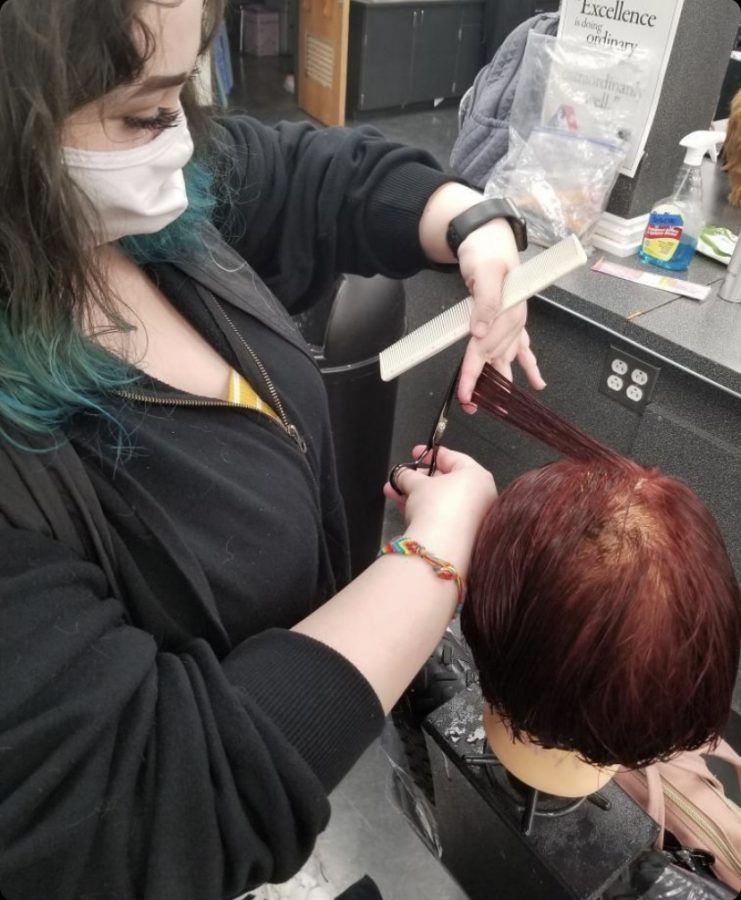 **Taking precaution…** *Wearing a mask, North Montco Technical Career Center junior Jenna Manfredi practices her cosmetology skills safely in the classroom during the current pandemic.*

*Photo by CeCe Ryan* 
