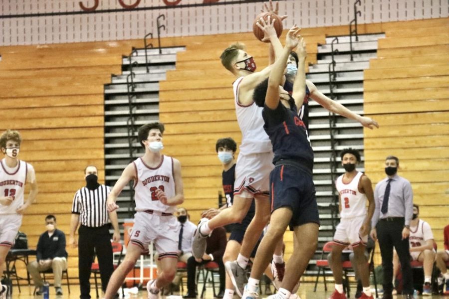 **Playing like a champion…** *Team captain Evan Kutzler (center) goes up for a two point shot with the help of Junior Paul Vince (left). The team faced CB East on March 1, 2021.*

*Photo by Ryan Moser*
