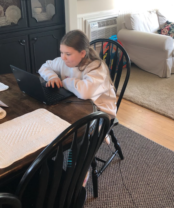 *Learning in the living room… Sitting in an online class, elementary school student Alivia Wilkins listens to read- aloud stories from her living room. Many students and parents alike are working from home due to the COVID-19 pandemic.*
