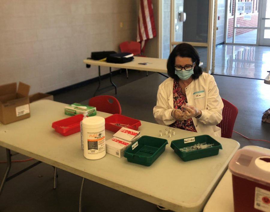 ***It all starts with a volunteer…**Rann Pharmacy employee Kim Diehl prepares syringes for injection. The school clinic hosted second vaccinations for students with the help of many volunteers. Arrowhead Photo by Everett Self*