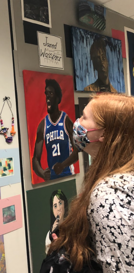 ***Bits and masterpieces...**Walking through the senior art show, senior Magen Swartley marvels at the artistry. The show was displayed outside the art hallway May 24-June 4. Arrowhead Photo by Tayler Garges*
