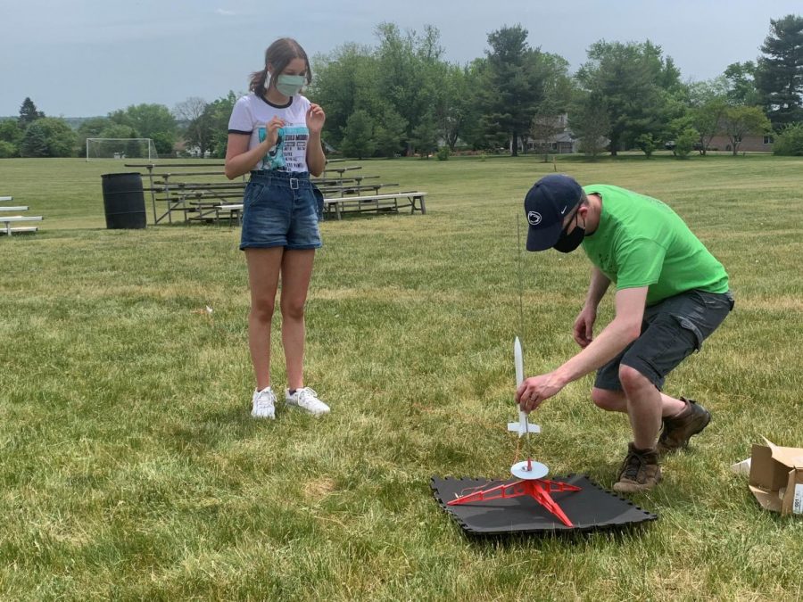 %2A%2A%2APreparing+for+launch...%2A%2ASetting+up+model+rockets%2C+astronomy+club+advisor+Patrick+Murphy+helps+sophomore+Felicia+Cappiello+place+her+rocket+on+the+launch+pad.+The+astronomy+club+built+model+rockets+on+May+19+and+launched+them+in+the+soccer+fields+on+May+22.%2A%0A%0A%2AArrowhead+photo+by+Erin+Gavin%2A+%0A