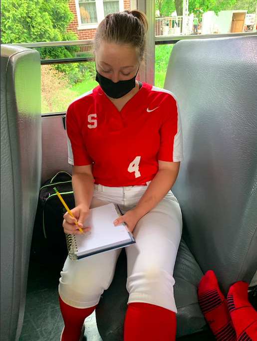 %2A%2A%2AWorking+on+the+go...%2A%2ATraveling+to+an+away+softball+game%2C+sophomore+Jess+Deery+creates+a+list+of+the+work+she+needs+to+accomplish+when+she+gets+home.+Having+had+to+leave+the+last+block+of+the+school+day+early%2C+Deery+used+the+time+she+had+on+the+bus+to+organize+herself.+Arrowhead+Photo+by+Alicia+Jones%2A+%0A