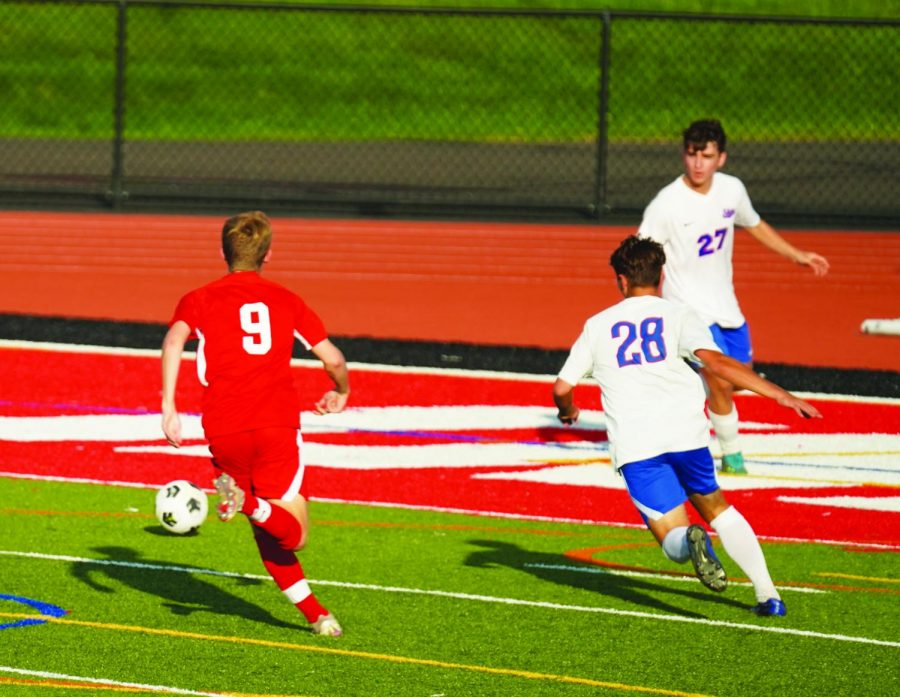 Face off…Racing to the ball, Souderton soccer player Nolan Hughes (left) and Neshaminy player Owen Biedeman press near the end line on Souderton’s end of the field during an October 4 out-of-division game. Souderton won the game 2-1.