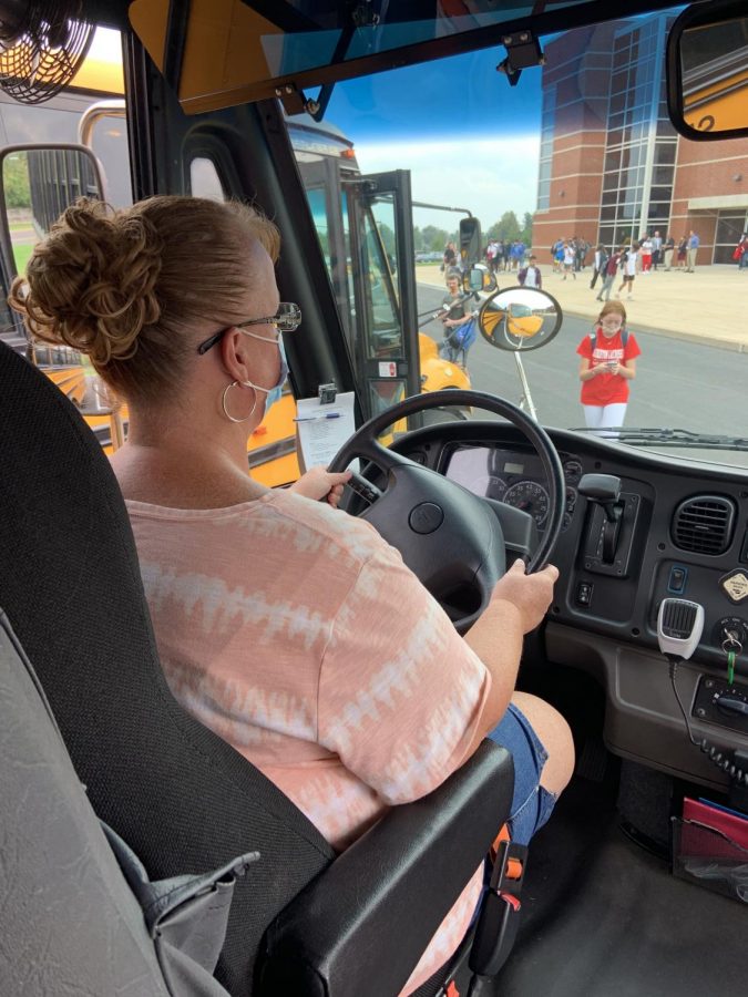 Hop on board…Waiting for students in the high school parking lot, bus driver Gwen Landes prepares the bus for departure. 