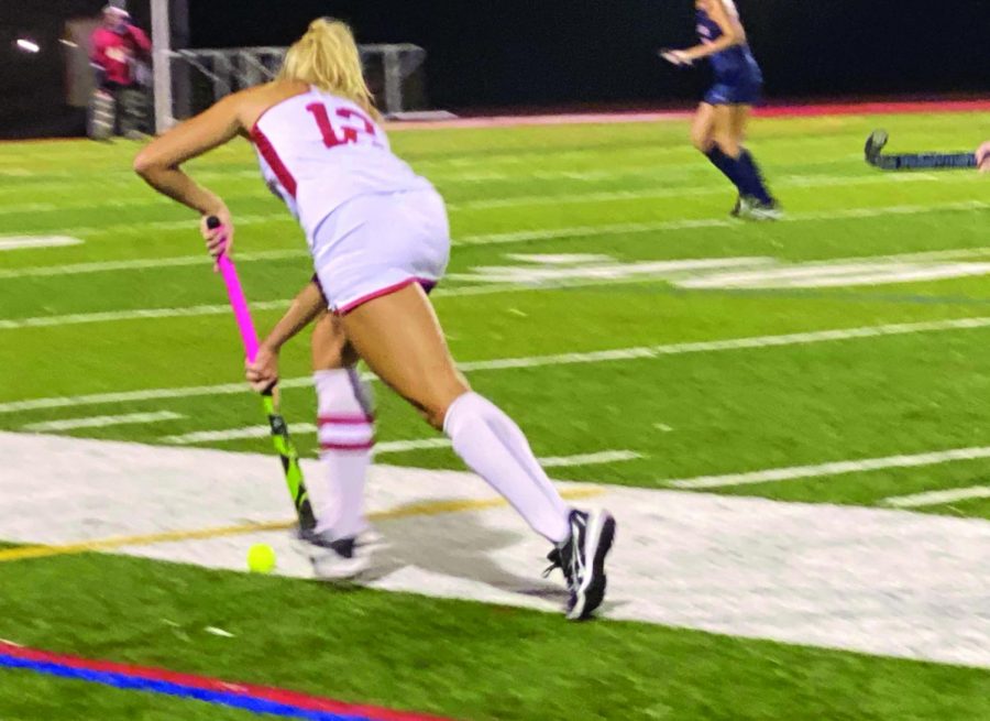 Going for the goal...Dribbling the ball down the field, girls field hockey captain Reiley Knize takes a shot against Neshaminy High School on October 4. October 4 was senior night and the team celebrated its seniors.