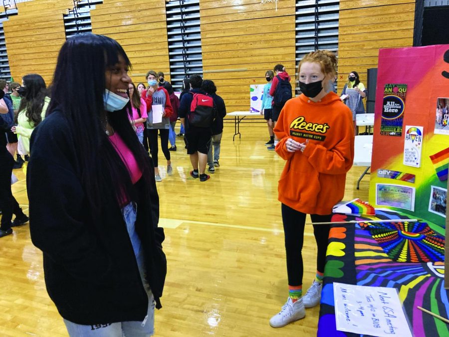 Creating connections...Managing the Gay Straight Alliance Club’s booth at the club fair on October 5, senior Alanna Hilton (right) speaks to freshman Mira Baker. The GSA’s goal was to recruit freshmen to join their LGBTQ+ supportive environment.
