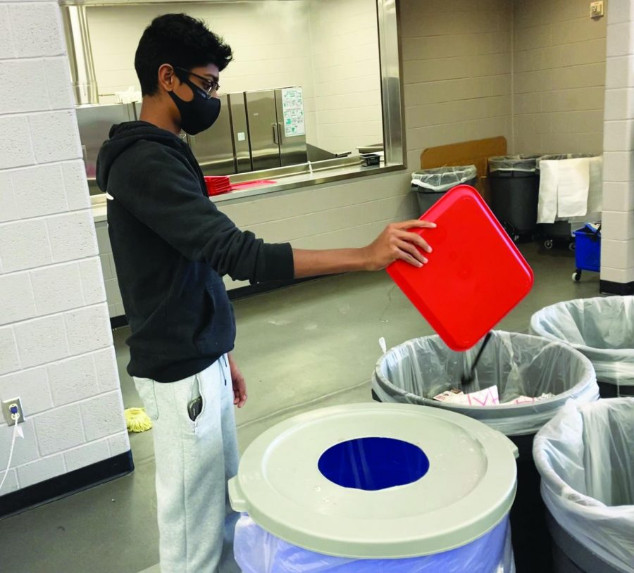 Cleaning up…After finishing lunch in the cafeteria on October 6, freshman Abel Mathew disposes his trash. The high school encourages students to responsibly dispose of trash.