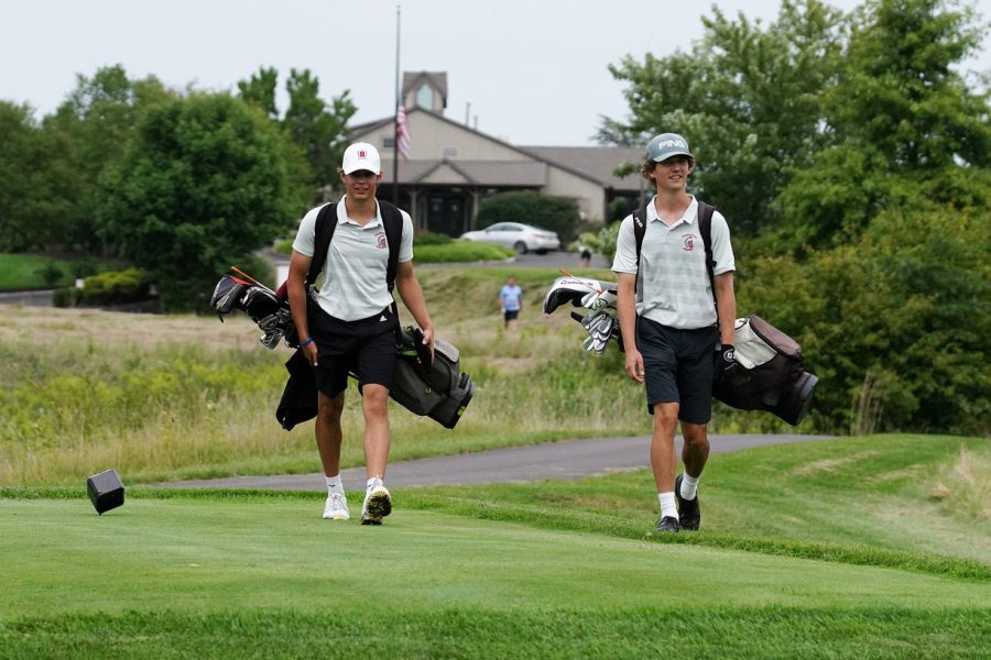 Tee-rific...Walking to the next hole, captains Kenneth Kreitz (left) and Jack Graboski talk strategy about their match against Central Bucks South High School. All home matches are held at Lederach Golf Course.