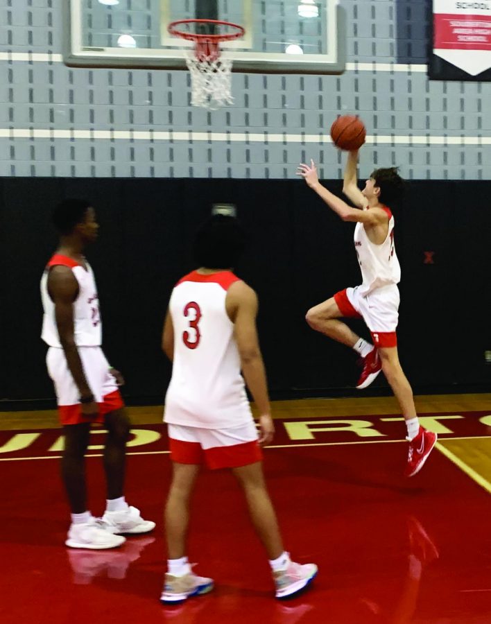 Going+up...During+a+recent+practice%2C+sophomore+Justin+Stauffer+prepares+to+make+a+layup.