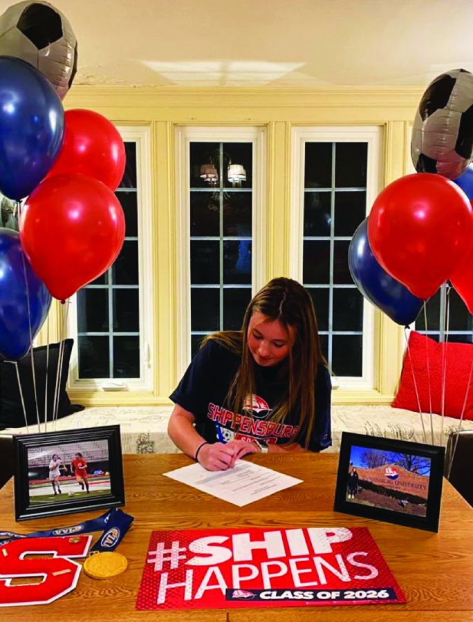 New beginnings...Signing the final documents, senior Kaitlyn Dicandilo commits to Shippensburg University for soccer. Dicandilo hopes to further her athletic career while attending her top college.
