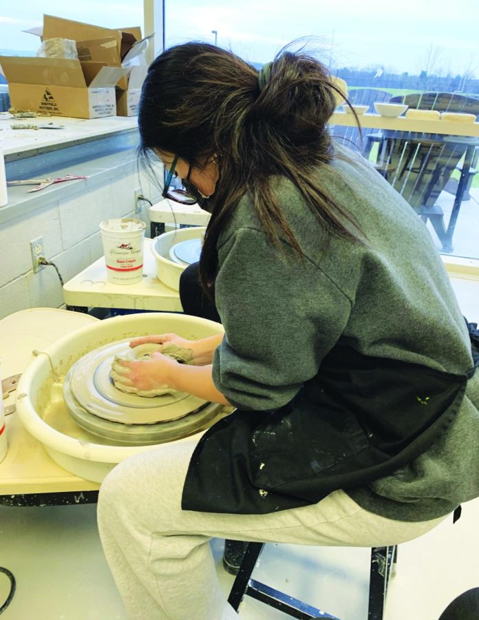 Ceramic Spinning…Throwing clay on the wheel, sophomore Ava Weismantel enjoy time during a recent Ceramics Club meeting. This new club meets every Thursday in room B120. Members hope to create fundraising opportunities in the future.