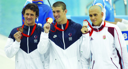 Winning the gold medal…After competing in the 2006 Beijing Olympics, (from  US Olympians Ryan Loche and Michael Phelps won the gold and bronze medals at the National Aquatics Center. They stand with Hungary’s Olympian Laszlo Cseh. Olympic athletes will be returning to Beijing this year for the Winter Olympics.