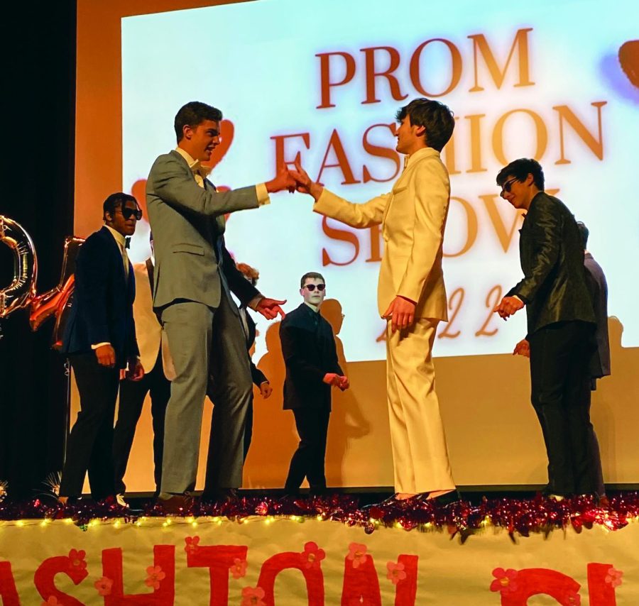 Bromance…Bumping fists, Prom Fashion Show models perform their choreographed dance on February 16. Thomas Smith (left) does a handshake fist bump for their performance with Tanner Yerton.