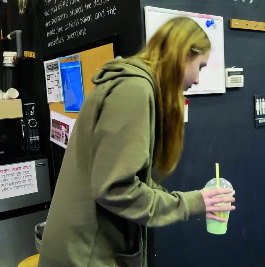 Shamrockin’ it…Jamming out to some pop music, sophomore Cayley Atkinson enjoys the sweet treat of her Shamrock Shake. The Shake is a limited-time offer at McDonald’s.