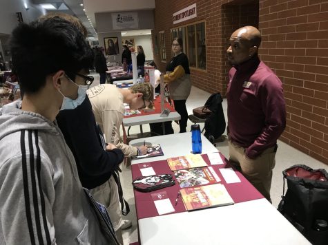 Making the rounds…While looking for potential schools, junior Chris Fu checks out Bloomsburg University’s table at the college fair on April 7. Bloomsburg University undergraduate admissions counselor Cerick Austin discussed with Fu why Bloomsburg may be a fit for him.