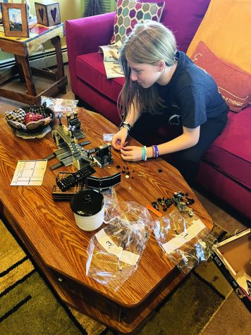 Creating piece by piece…Building The Batman Lego set, sophomore Morgan Heckman follows instructions to complete the build. Heckman, along with others, spent multiple hours making the large build. 
