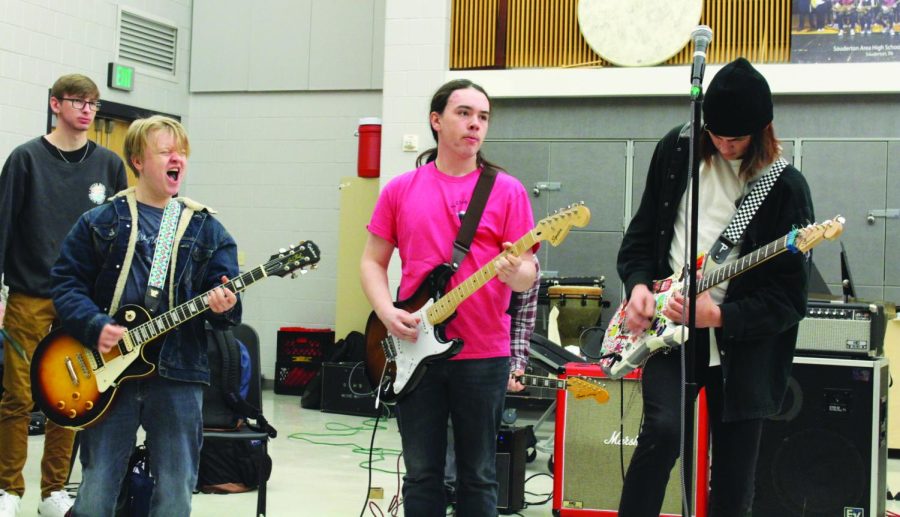 mped up...Rehearsing a song, (from left) senior James Baker, senior Andrew Febus and junior Sean Coughlin jam out on their guitars. The group meets every other day as a rock band class to play a variety of rock music. During the school day, performances sometimes take place in the cafeteria over lunch.