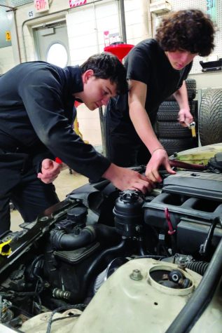 Under the hood…Working on a BMW in the North Montco Technical Career Center automotive shop, sophomores Dane Soulliard (left) and Keiran Maldonado display their precision and focus. 