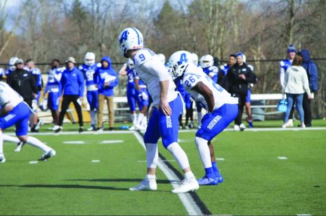 Touchdown in the making…Preparing for the next play, Assumption College quarterback Jacob Cady (center) and running back Raekwon Washington play in a spring scrimmage against their defense earlier this year.