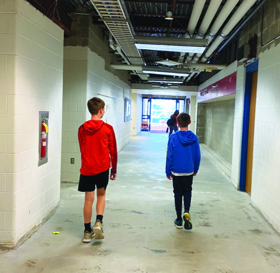 Peeking at the progress…While their school is being renovated, Indian Valley 7th graders Tyler Goodman (left) and Carter Nice investigate the construction.