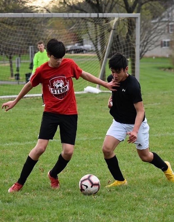 Defending a run…Doing his best to stop a promising attack, soccer player Josh Benavides defends fellow player Andres Shinn. The two faced off in a friendly scrimmage during the summer.
