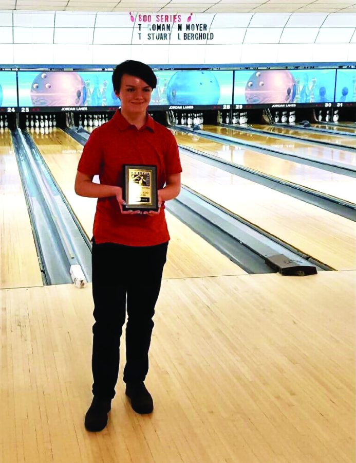 Striking out...Presenting her plaque, sophomore Elizabeth Hercek celebrates her accomplishment. After competing in the Junior Masters tournament, Hercek placed second. 
