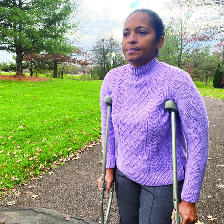 Ouch…Demonstrating what could happen if one is not being safe during the holiday season registered nurse Mishael Gayle leans on crutches. It is important to remember that safety is important even during the holidays. 
