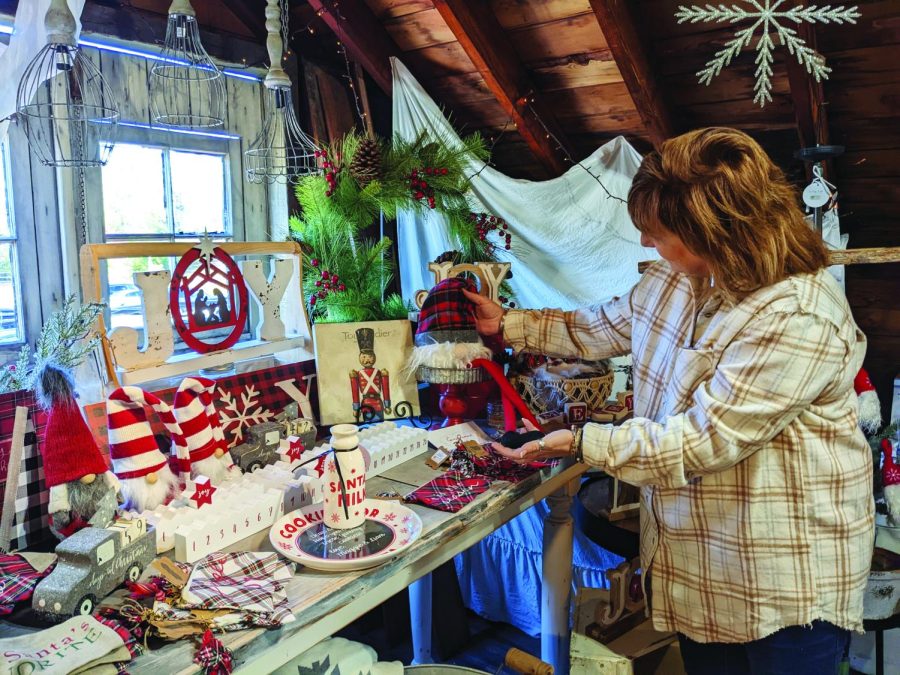 Deck the halls…Spreading holiday cheer, The Copper Partridge owner Deb Knight creates a cheerful atmosphere. Many small businesses began decorating for the holidays towards the end of November.