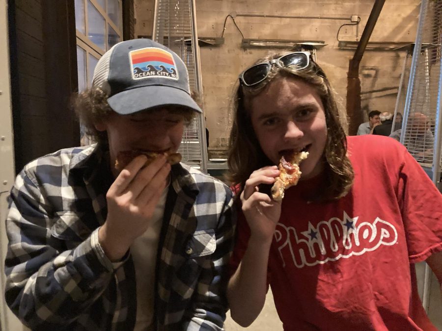 Taking+a+bite...Finding+themselves+in+the+midst+of+a+good+meal%2C+sports+editor+Brogan+Sullivan+%28Left%29+and+website+manager+Jacob+Godshall+enjoy+their+last+bites.+The+pair+ate+their+dinner+at+Pizzeria+Beddia+in+Philadelphia.