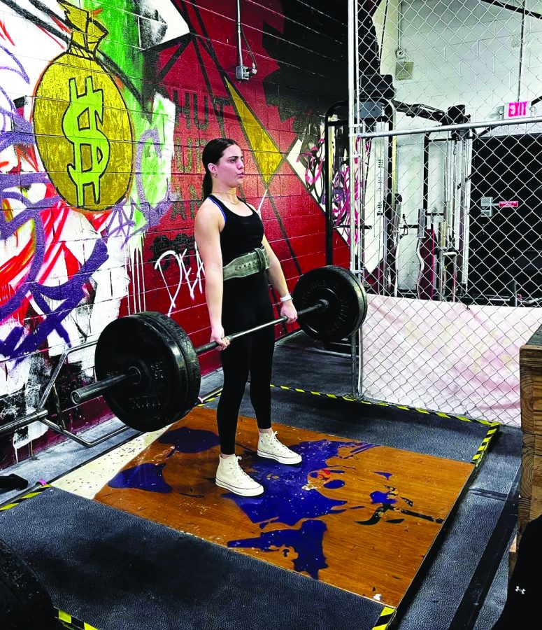 Smashing glass ceilings…Pushing her limits, senior Emily Tuttle lifts at her local gym. For Tuttle, working hard has made her more comfortable in the weight room.