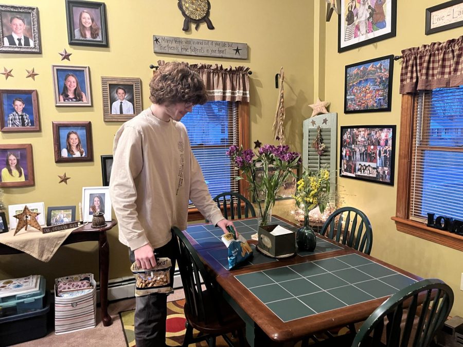 Arranging…preparing for the weekly night of watching football, Philadelphia Eagles fan Grant Means works on decorating his dinner table for the perfect party. Lots of pride is taken with a good football-watching set-up. 