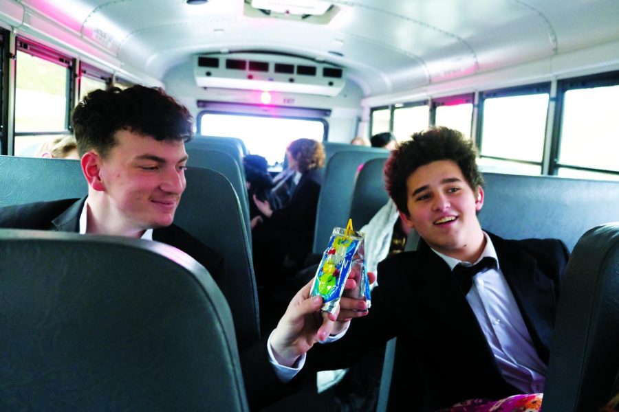 Cheers!...Celebrating their music program, advanced choir members Mason Miller (left) and Holden Finley toast with Capri Sun juice pouches prior to their performance at the state capitol building on March 12.