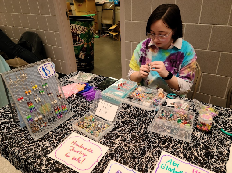 Eye for design...Crafting handmade jewelry throughout the night, senior 
Abigail Gladwell promotes her art during Art and Soul Fest on March 18.