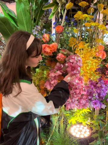 Becoming florastruck… Enjoying the beautiful entrance walkway, Arrowhead photography 
editor Zoe Bass admires a flower display. Extra thought was put into the entrance this year as 
organizers hoped to make the show’s return to the Phila. Convention Center more enticing.