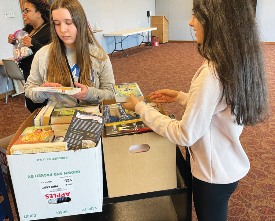 Fully booked…Sorting donations, Key Club officers Renae Benner (left) and Vrushi Patel 
unpack books collected through the Key Club book drive held February 10-28. 