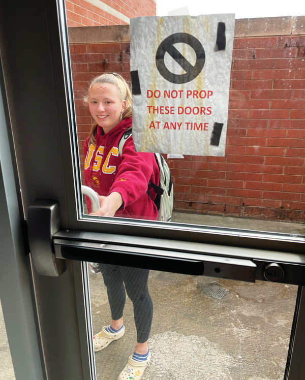 Securing the school...Trying to enter the school, Souderton swim instructor Anna Bishop tries to use the door that is usually propped open. The door that was usually open was closed to promote school safety. 
