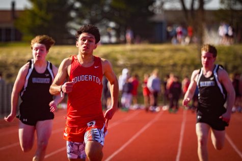 Track star...Crossing the finish line, senior Johnny Argueta beats opponents in a Quakertown scrimmage on March 20. Argueta ran 12.12 seconds in the 100 meters. 