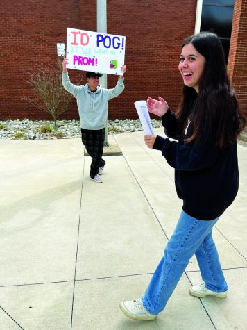 Hoppy prom...Seeking a date for the May 19 senior prom, senior Adam Ellmore surprises senior Jami Garrison with a homemade poster promposal. The poster read, “I’d pog if we went to prom!”