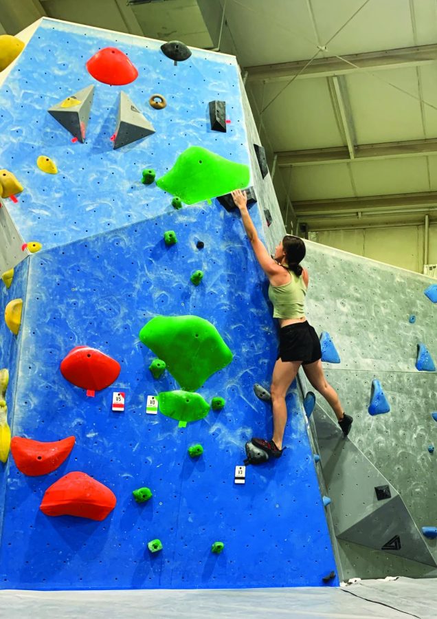Reach+for+the+stars%E2%80%A6Pushing+herself+to+finish+a+hard+climb%2C+senior+Ava+Beskar+successfully+makes+the+grab+for+a+difficult+hold+while+rock+climbing.