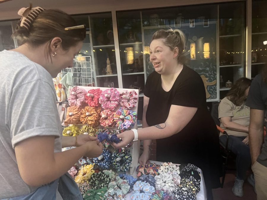  Sharing scrunchies and more...Selling accessories, small business owner Sarah Alldred (right) shares her handmade scrunchies with customer Bea Gallowky at the 3rd Friday event. On May 20 vendors from local businesses such as RaRa Creative sold their items on Main Street. 