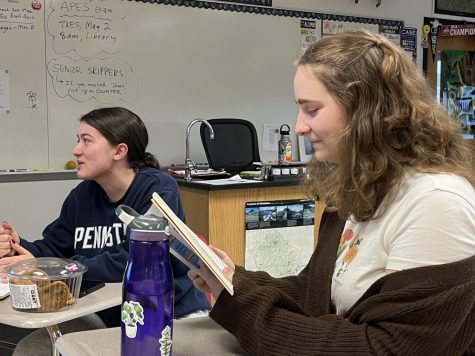 Discussing the story...Conversing during a meeting, seniors Audrey Harman (left) and Grace Lettero talk about their opinions on the book they read for April 28 meeting. 