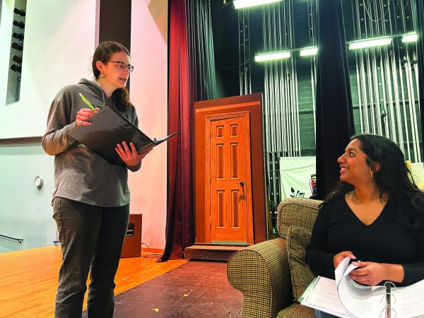 Directing with a purpose...During fall play practice, 2019 Souderton alumna Katie Stoneback (left) presents notes to senior Sarah Thomas for her character, Olivia Porter, in Stonebeck’s original play, “Where There’s a Will, There’s a Murder.” 