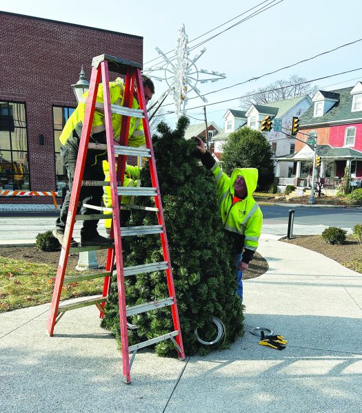 ‘Tis the season...Preparing for Souderton’s annual tree lighting on December 1, Public Works employees (from left) Seth Renner, Dave Yoder and Tim Kelly put together the top of the tree in Univest’s parking lot. 