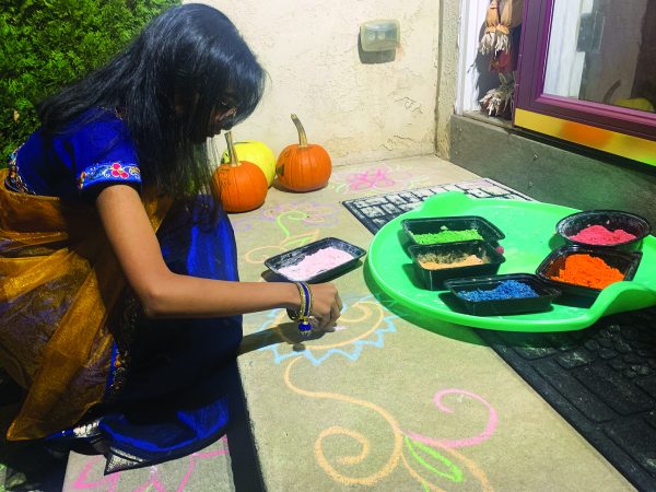 Making art…Using Rangoli, junior Anuhya Vemagiri decorates her porch to make it look nice for Diwali. The festival took place on November 12-17, with Hindus celebrating something different each day.
