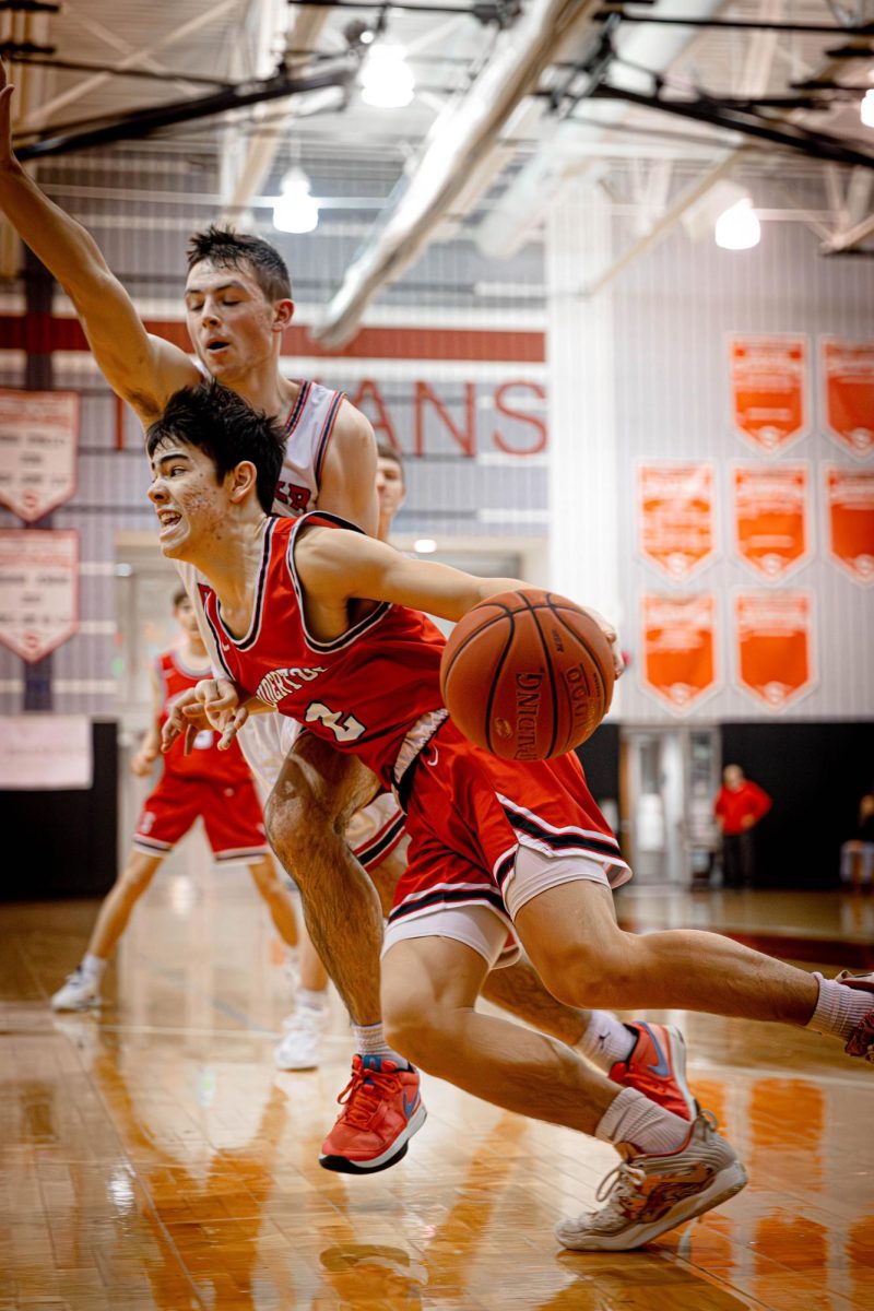 On the move...Dominating the court, junior varsity captain Trey Bui fights to the basket against Upper Dublin High School during December’s Jim Church Classic.